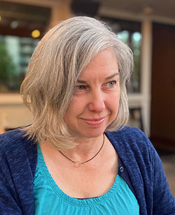 Kirsten Day, a woman with a blue sweater