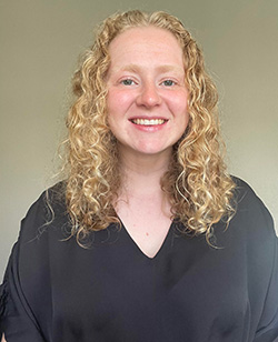 Alison Lawrence, a n Augustana student with curly hair and a black shirt