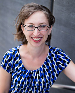 Donna Hare, a woman with glasses and a blue and white shirt